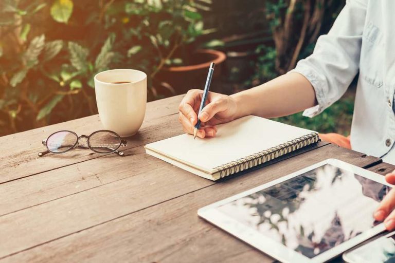 Lady quietly journaling outdoors