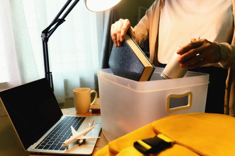 Lady packing away desktop items