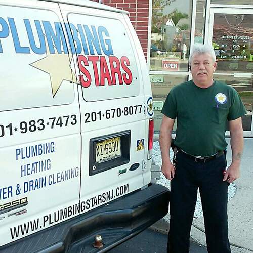 Plumber standing in front of his plumbing vehicle