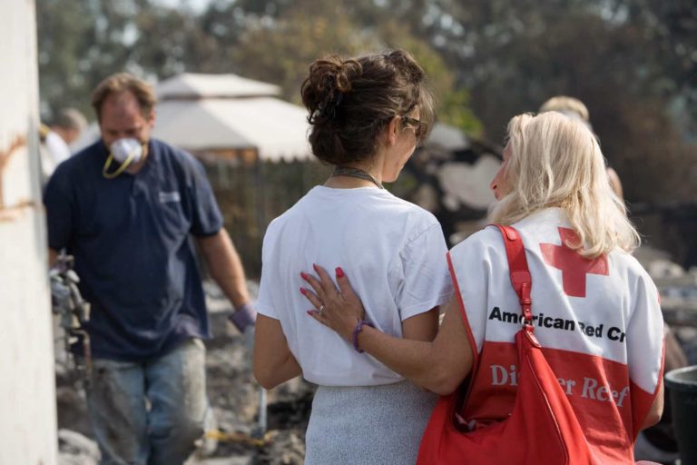 Red Cross volunteer comforts victim