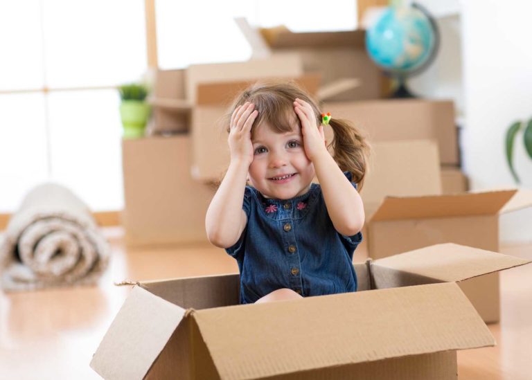 Little girl sitting in a box