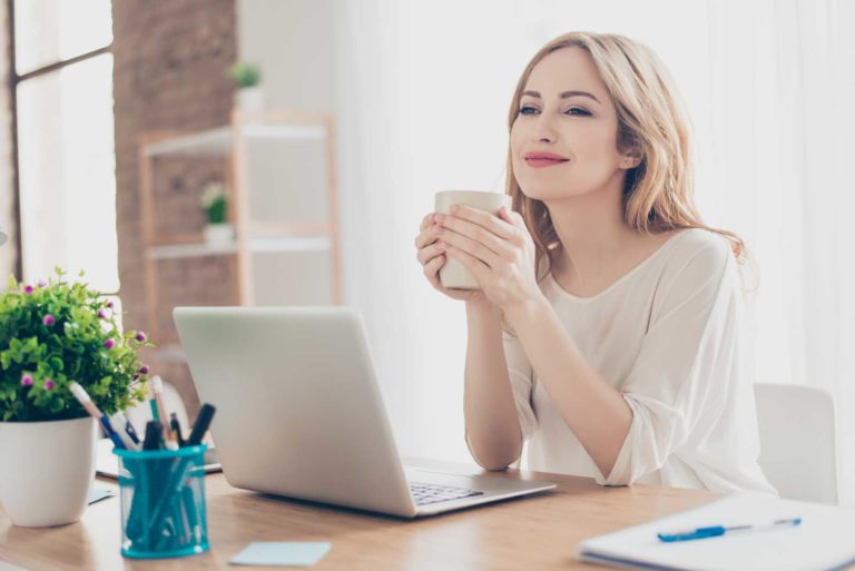 Lady enjoying coffee at work station