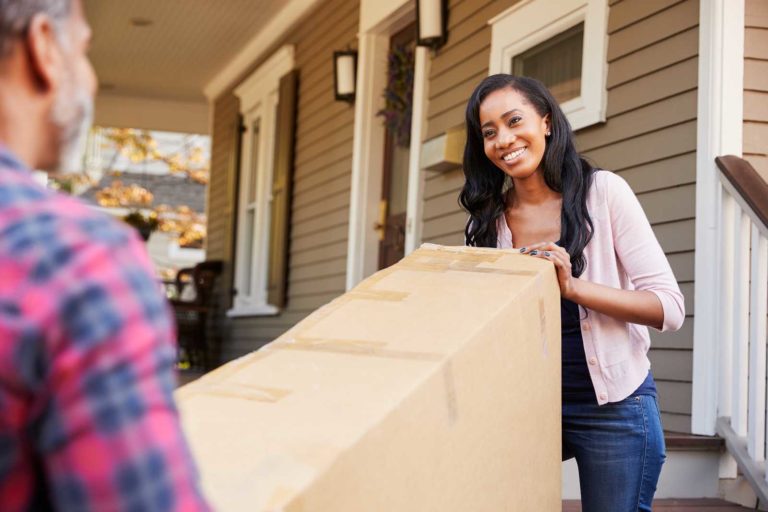 Two people moving a box