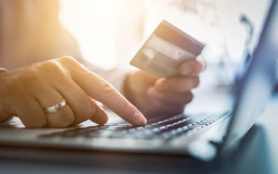 Lady securely entering card info into laptop