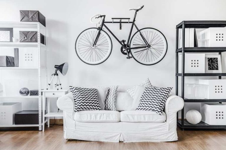 WHite themed living room with new bike placed upon the wall