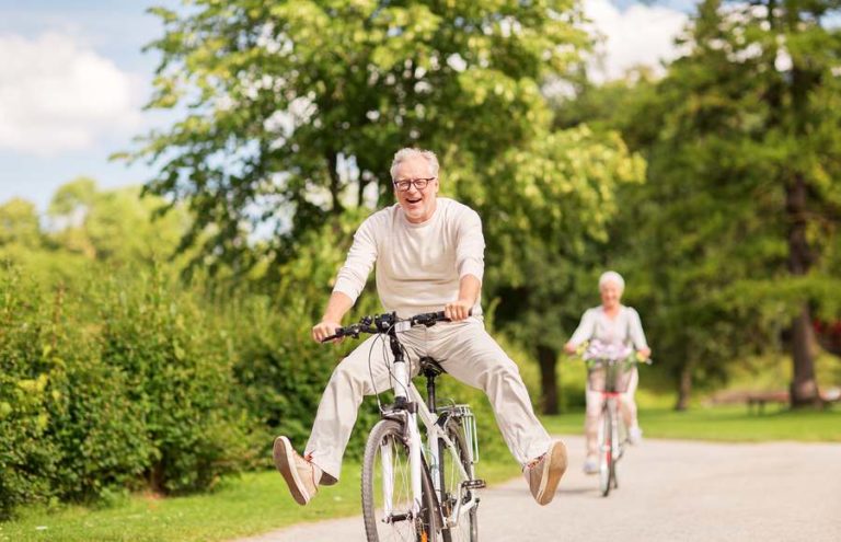 Senior riding bicycle enjoying his time