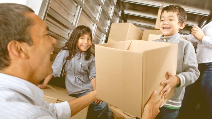 Family working together to move boxes