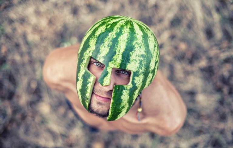 Man with a watermelon on his head