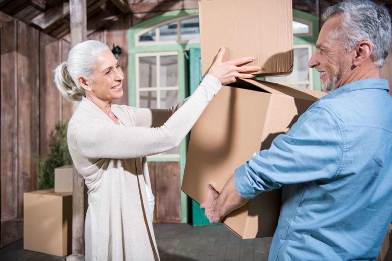 Older couple moving boxes together