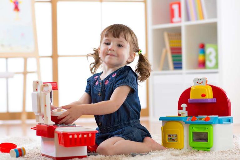 Little girl enjoying playing with toys