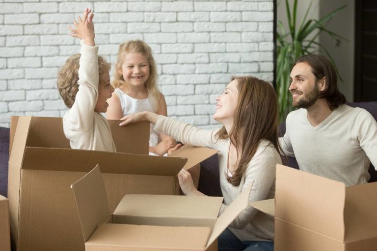 Family bonding playing in moving boxes