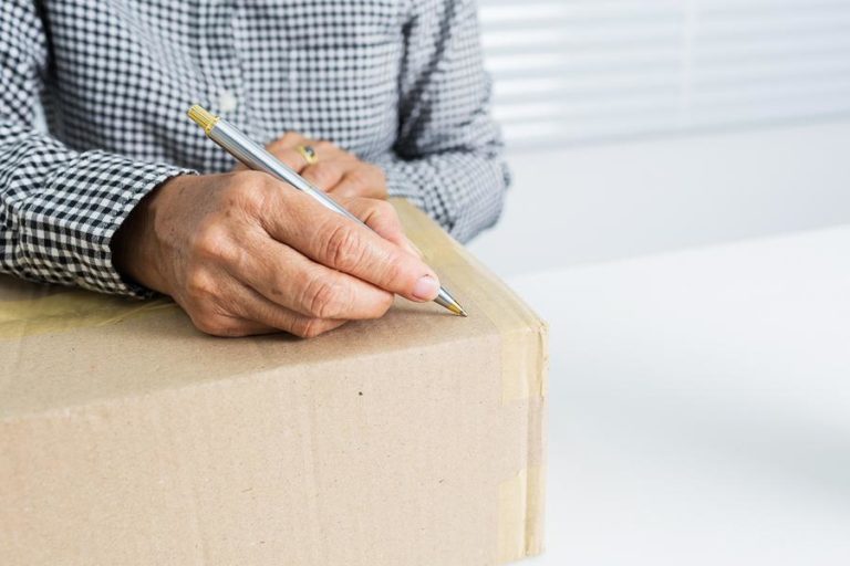 Man marking box for labeling