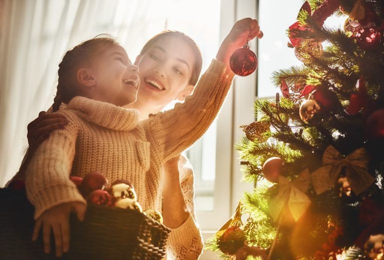 Mom and Daughter decorating Christmas Tree