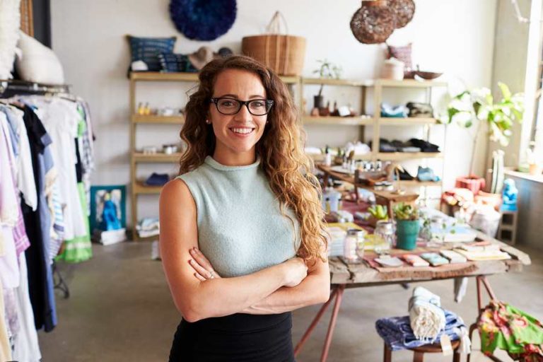 Lady posing in front of her business