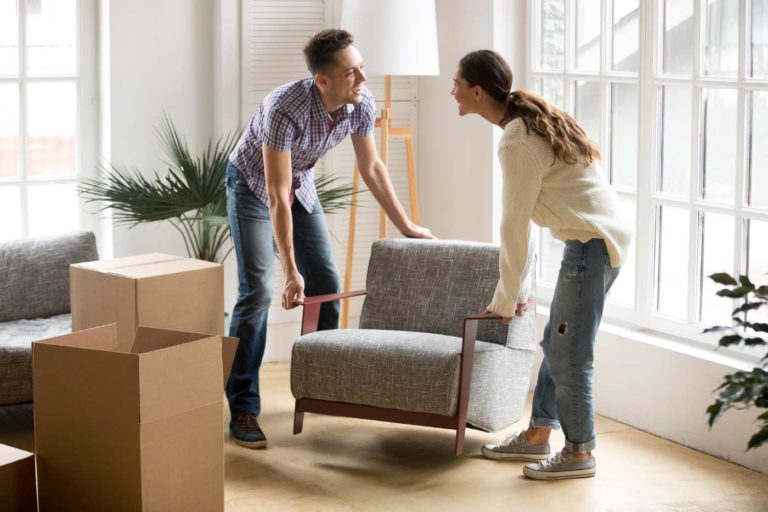 Two people moving a chair