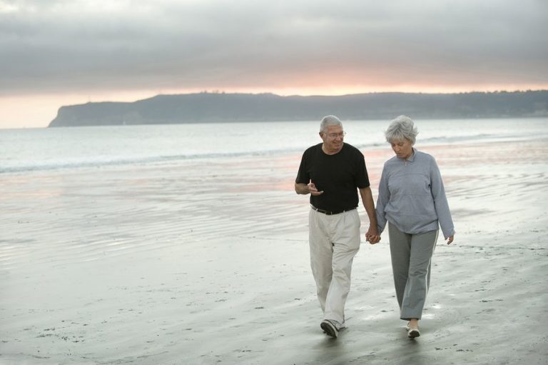 Senior couple walking along the beach