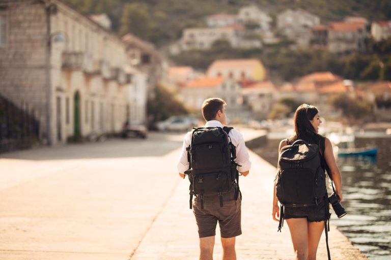 Two people walking along pier