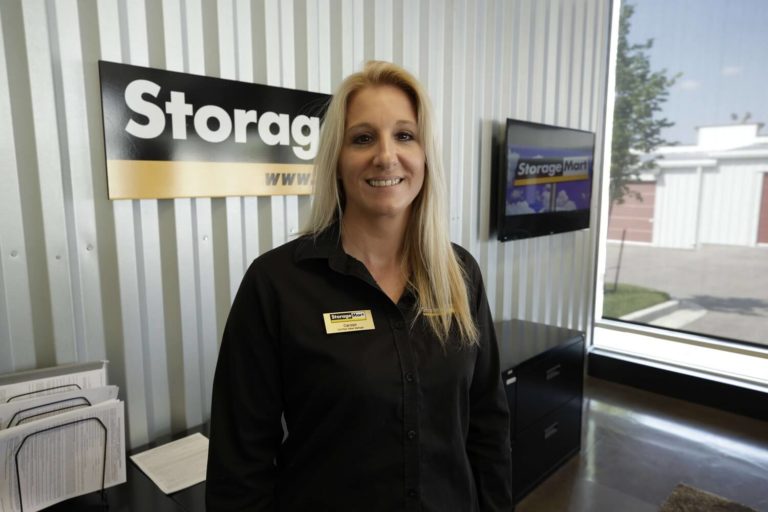 Smiling StorageMart store manager