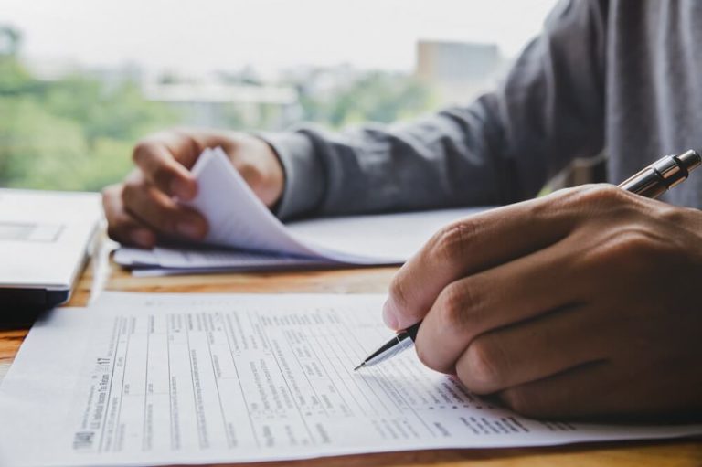 Man filling out tax paperwork