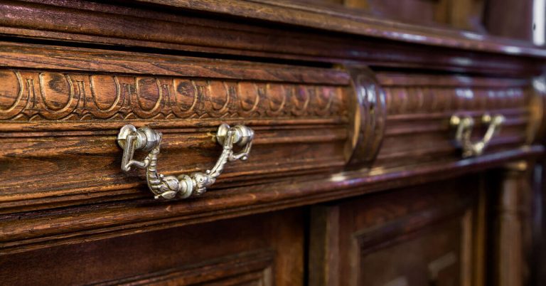 A close-up shot of an antique wood dresser