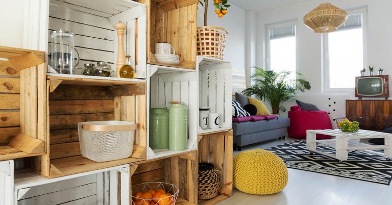 An assortment of wooden crates are stacked to create a DIY shelving unit.