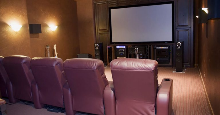 A home theatre with comfy chairs.
