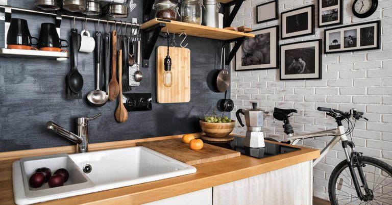 A kitchen gets organized with the help of hooks and shelves.