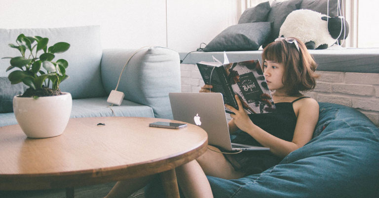 a young woman reads in a bean bag chair