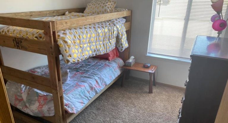 bunk beds with patterned duvets in a furnished room