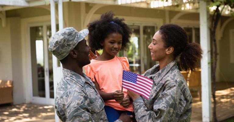 a military family in front of their home