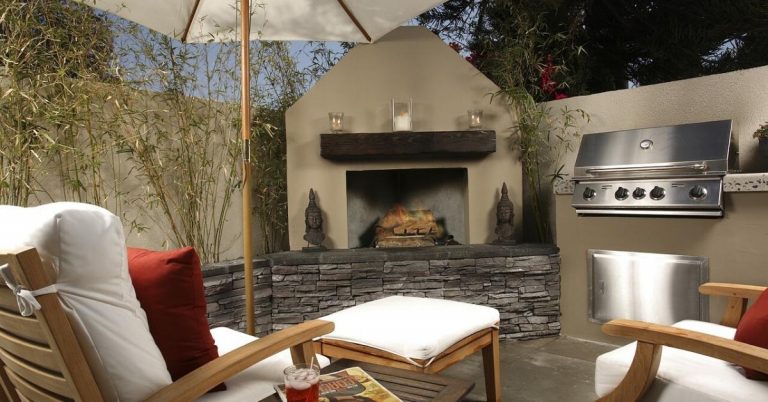 Backyard outdoor living space with patio furniture and grill.