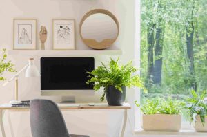 a home office with the desk situated so the person who will work at the desk can look out at the greenery outside the window