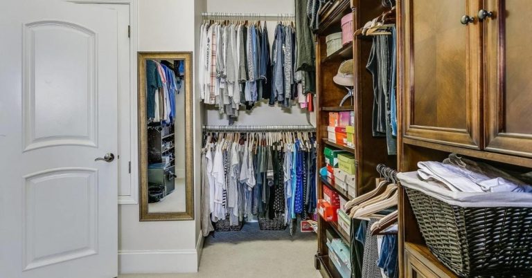 An organized closet with shirts and shoes.