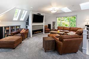 A spare room converted into a den with seating and bookcases. 