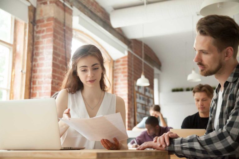 Two people reviewing papers