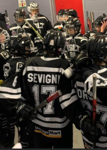 Young hockey players huddling before a game.