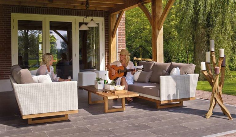 Women plays guitar on patio