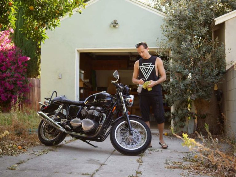 Man stands next to freshly cleaned motorcycle
