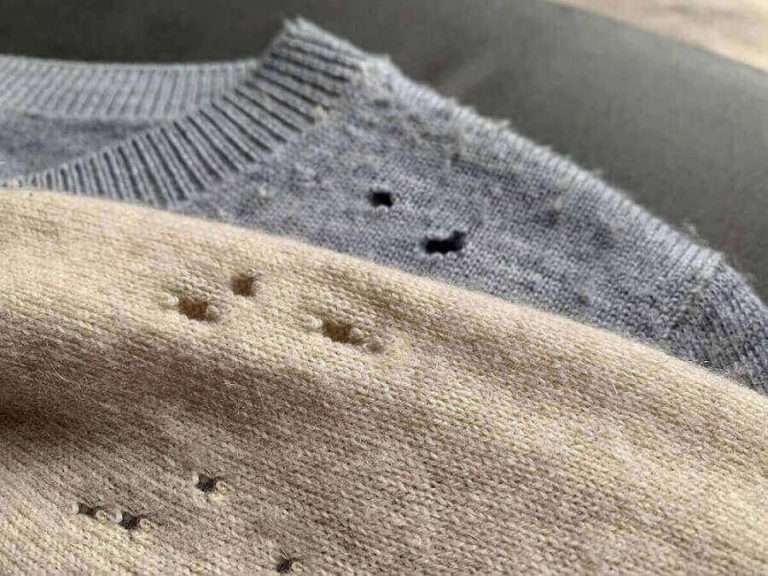 Two sweaters showing the aftermath of clothes moths