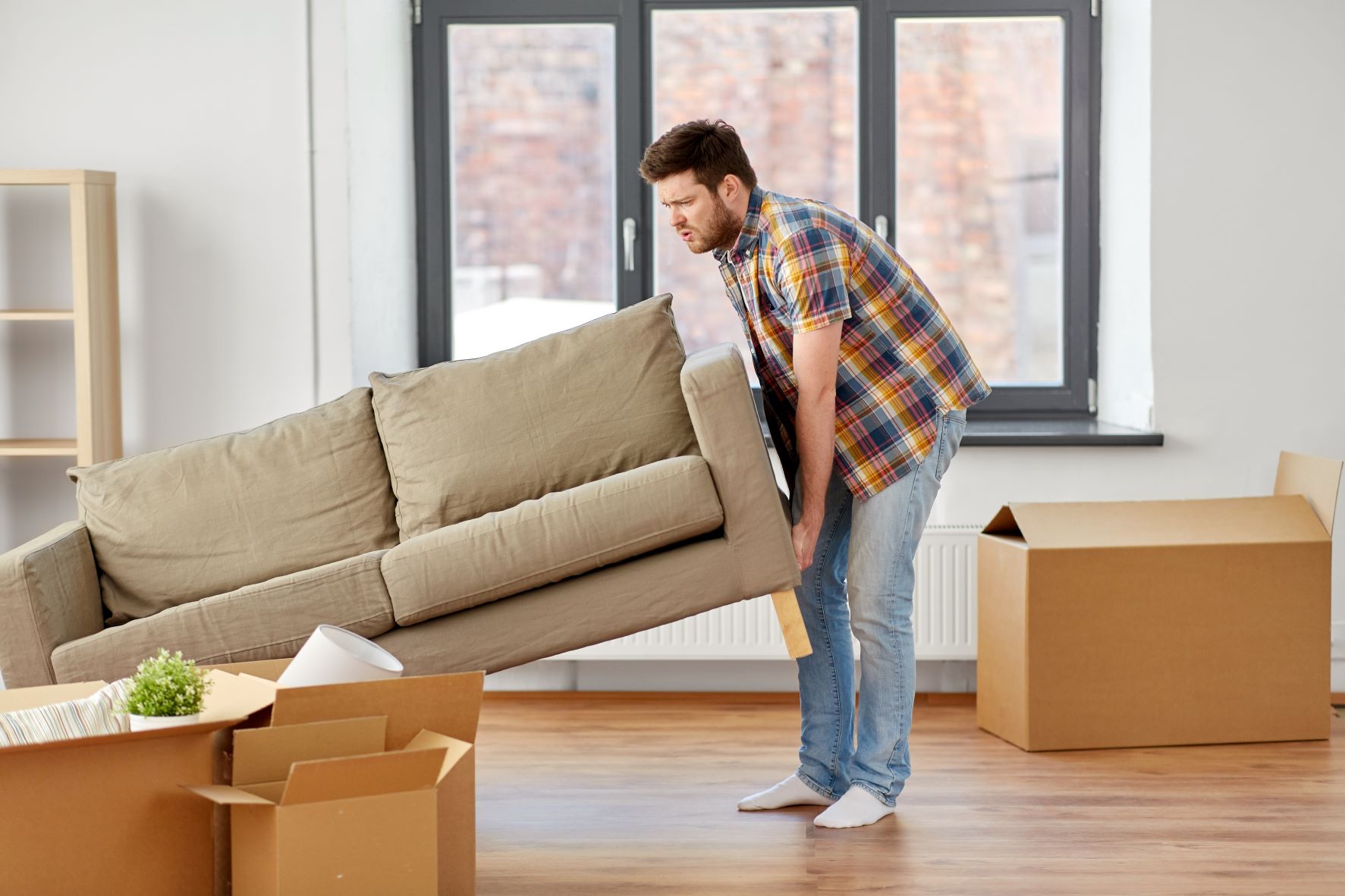 man moving couch alone