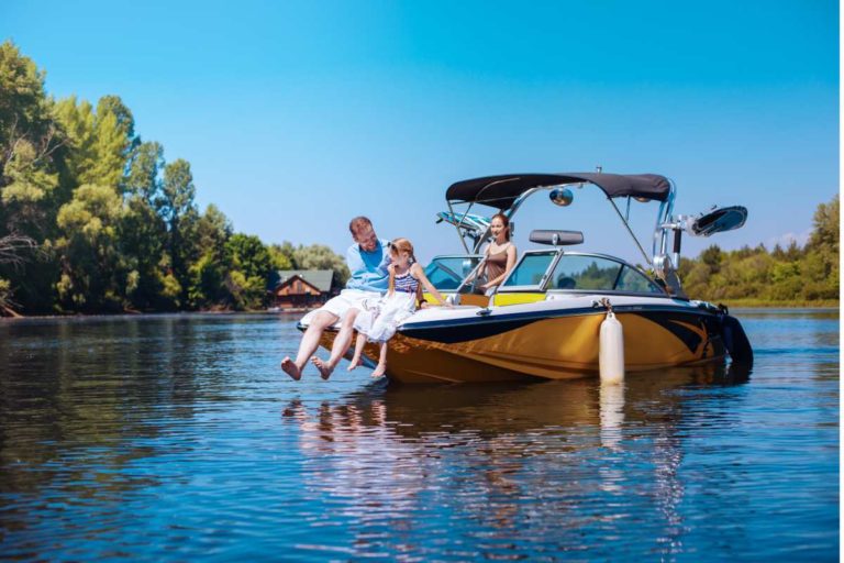 Family sitting on boat enjoying the water and weather