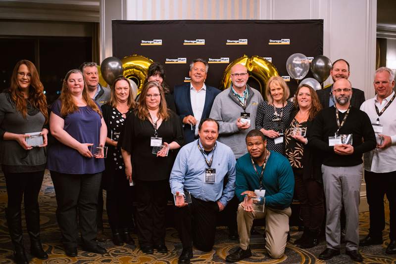 StorageMart stories / Employees posing with award