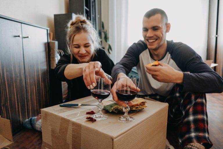 couple drinking wine on box