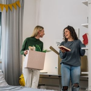 Ladys talking and moving boxes